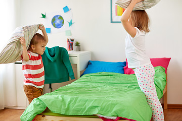 Image showing kids playing and fighting by pillows at home