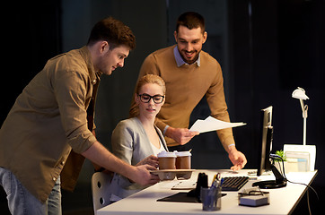 Image showing business team with computer working late at office