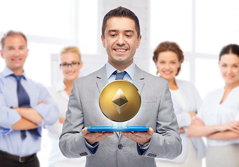 Image showing smiling businessman with etherum over tablet pc