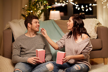 Image showing happy couple eating popcorn at home