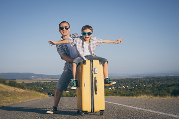 Image showing Father and son standing in the park at the day time.