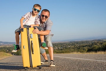 Image showing Father and son standing in the park at the day time.