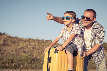 Image showing Father and son standing in the park at the day time.