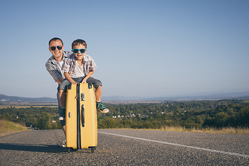 Image showing Father and son standing in the park at the day time.