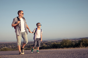 Image showing Father and son standing in the park at the day time.