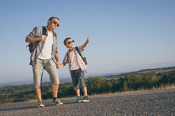 Image showing Father and son standing in the park at the day time.