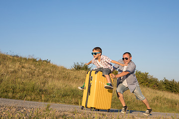 Image showing Father and son standing in the park at the day time.