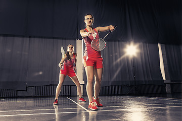 Image showing Young women playing badminton at gym