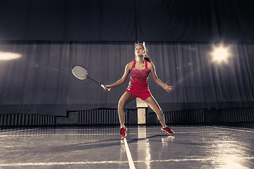 Image showing Young woman playing badminton at gym