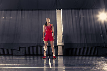 Image showing Young woman playing badminton at gym