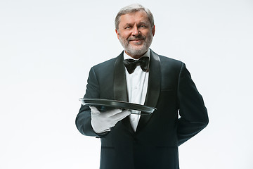 Image showing Senior waiter holding tray