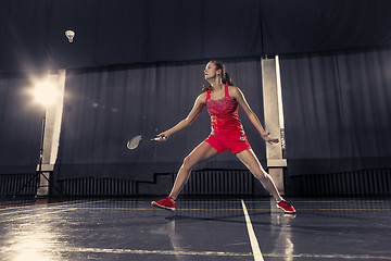 Image showing Young woman playing badminton at gym