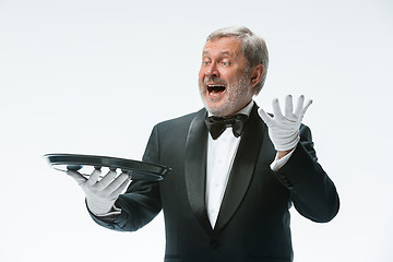 Image showing Senior waiter holding tray