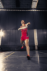 Image showing Young woman playing badminton at gym