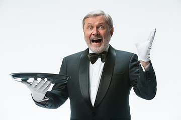 Image showing Senior waiter holding tray