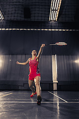 Image showing Young woman playing badminton at gym