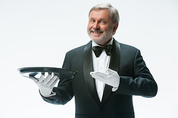 Image showing Senior waiter holding tray