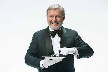 Image showing Senior waiter holding bell