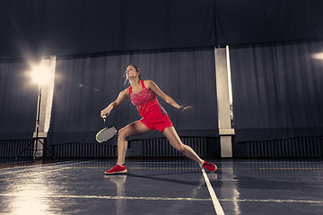 Image showing Young woman playing badminton at gym