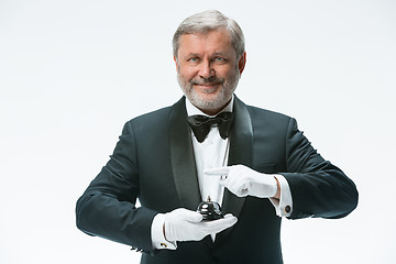 Image showing Senior waiter holding bell