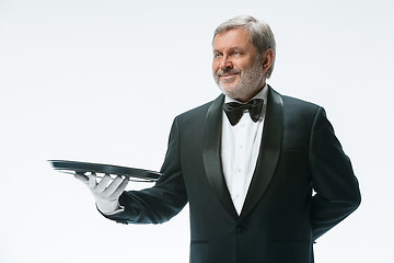 Image showing Senior waiter holding tray