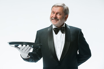 Image showing Senior waiter holding tray