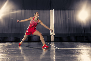 Image showing Young woman playing badminton at gym