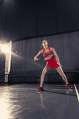 Image showing Young woman playing badminton at gym