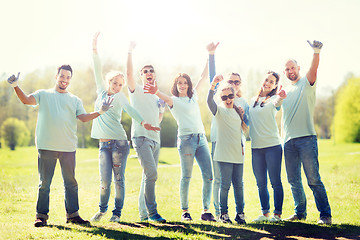 Image showing group of volunteers showing thumbs up in park