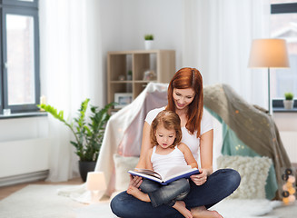 Image showing happy mother with little daughter reading book