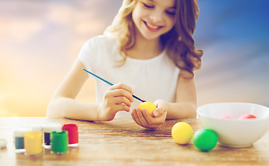 Image showing close up of girl coloring easter eggs