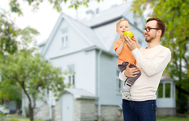 Image showing happy father and little son with green apple