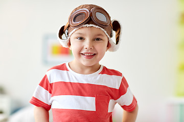 Image showing happy little boy in pilot hat at home