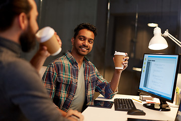 Image showing creative team drinking coffee at night office