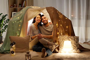 Image showing happy couple in kids tent at home