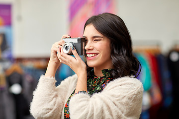 Image showing smiling woman photographing by vintage film camera