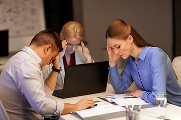 Image showing business team with laptop working at night office