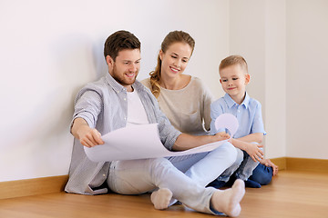 Image showing happy family with blueprint moving to new home