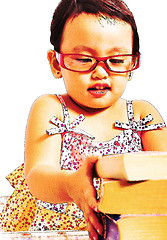 Image showing Girl Picking Up A Pile Of Books To Read