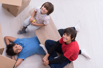 Image showing boys with cardboard boxes around them top view