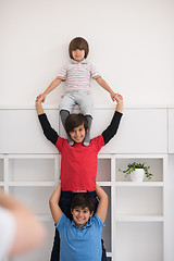 Image showing young boys posing line up piggyback