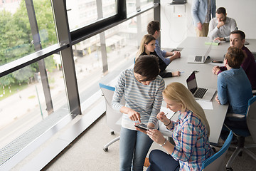 Image showing Pretty Businesswomen Using Tablet In Office Building during conf