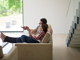 Image showing Young couple on the sofa watching television