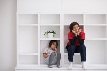 Image showing young boys posing on a shelf