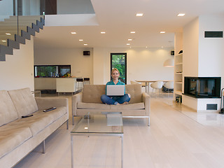 Image showing Young woman using laptop at home