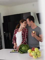 Image showing Young handsome couple in the kitchen