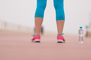 Image showing close up on running shoes and bottle of water