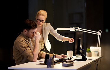 Image showing business team with computer working late at office