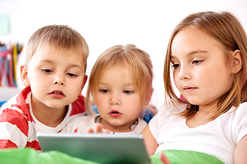 Image showing little kids with tablet pc in bed at home