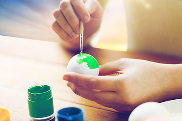 Image showing close up of woman hands coloring easter eggs